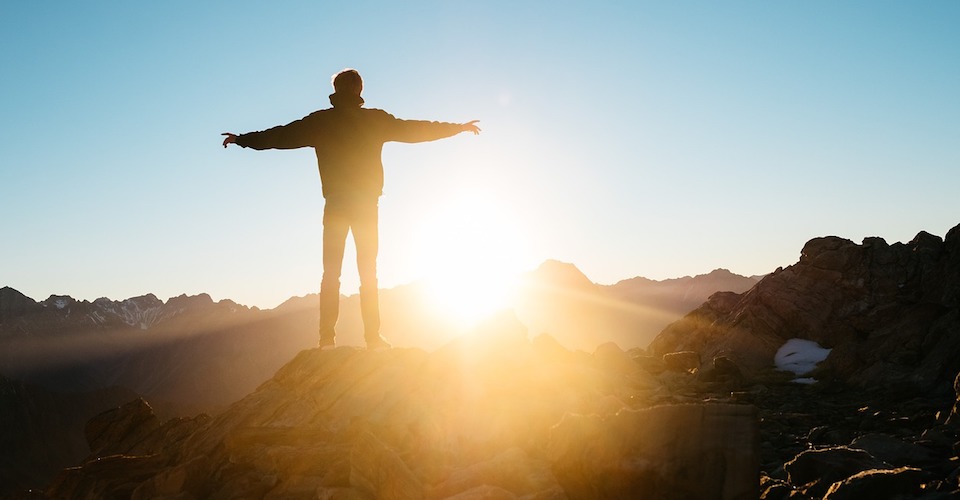 Backlit Man on Mountain Arms Out backlit man on mountain arms out