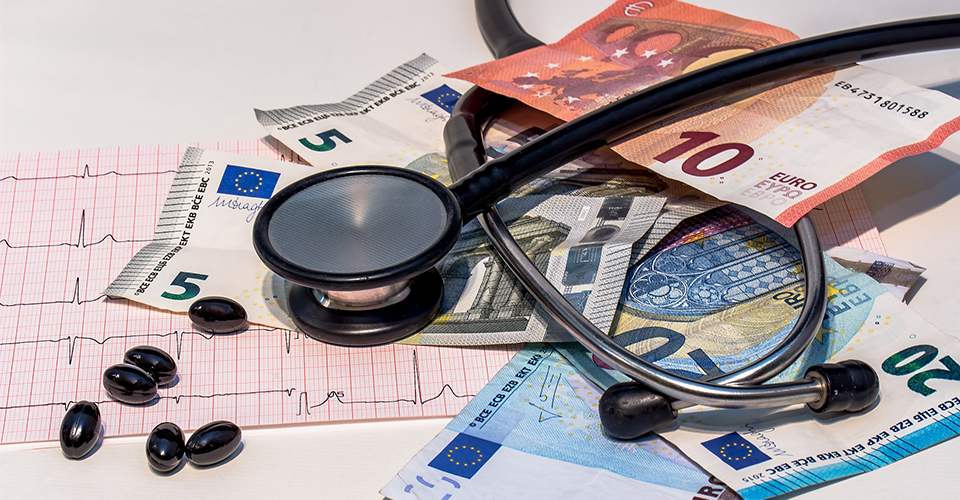 stethoscope on money and med chart
