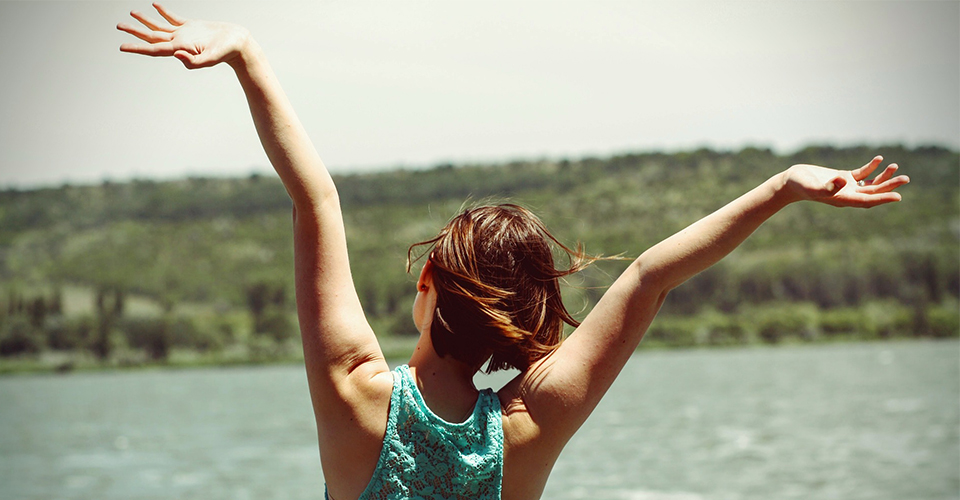 Woman with Raised Hands Near Water woman raised hands near water